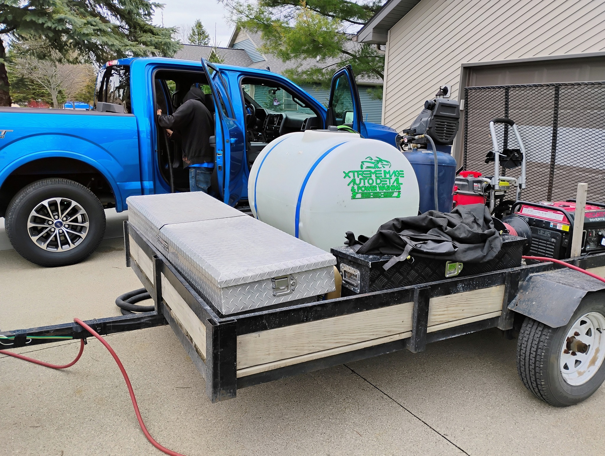 Professional detailer polishing a car